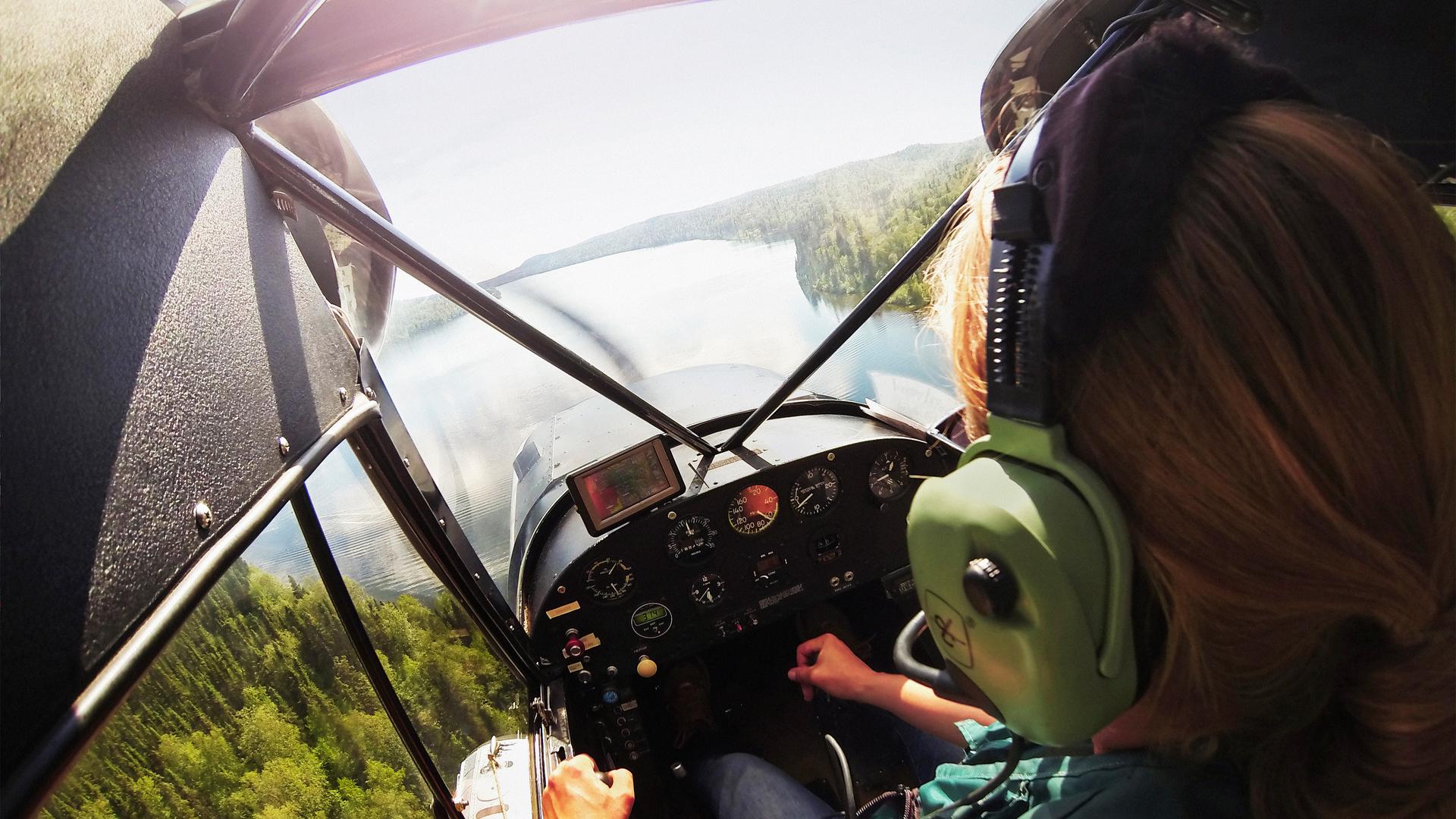 Cockpit view of a plane flying over a river