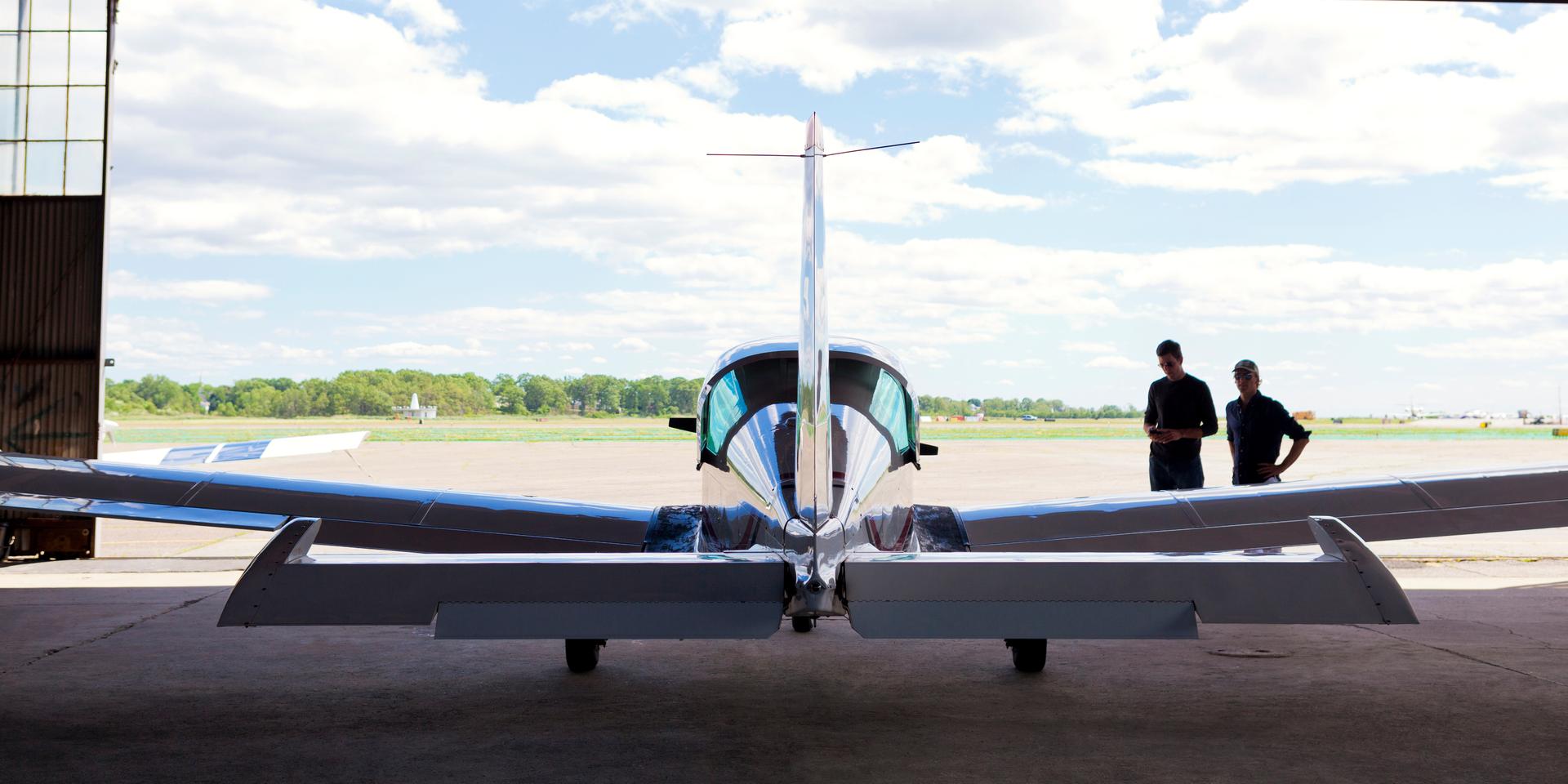 plane pointed out open hangar doors