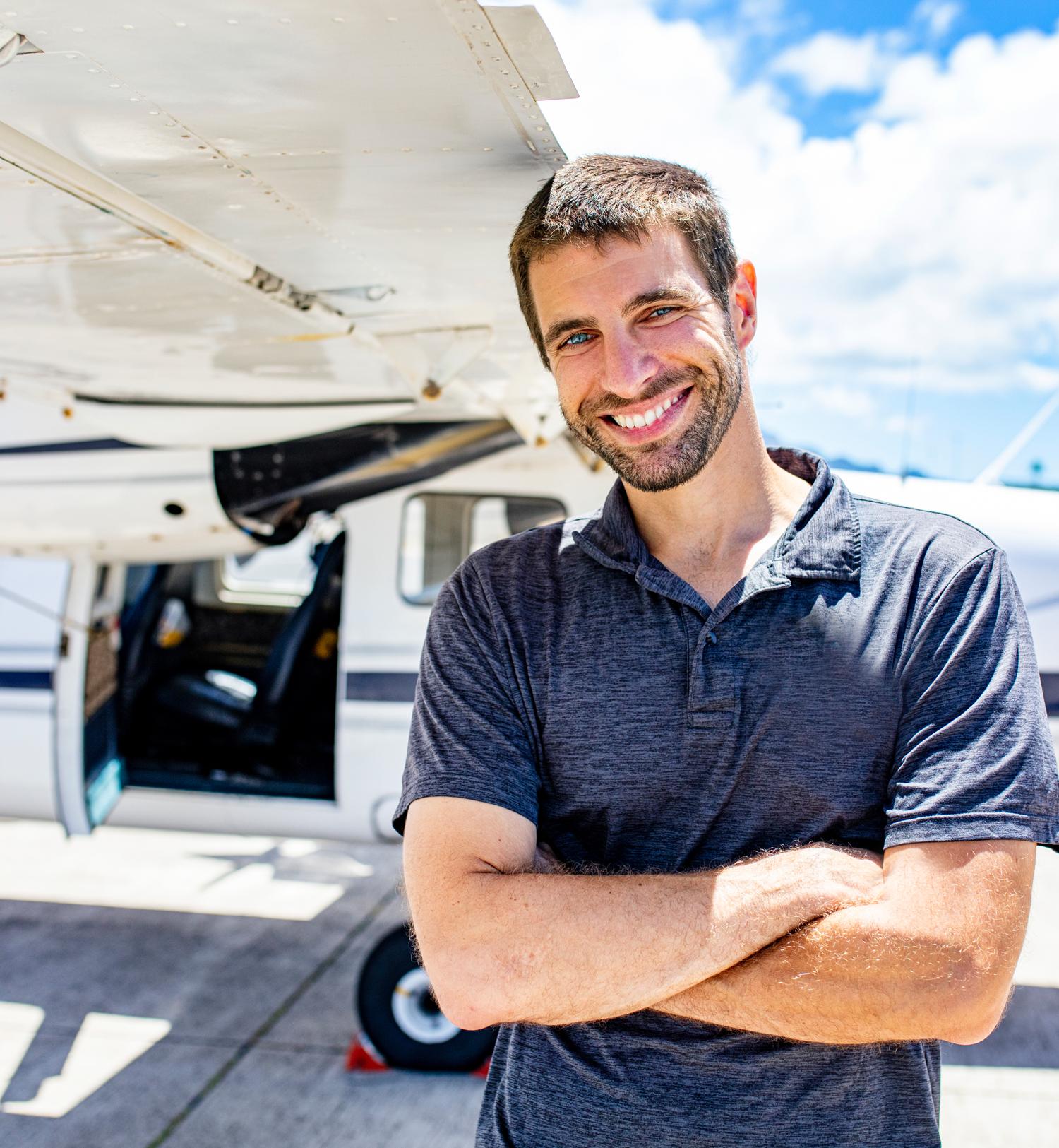 smiling pilot in front of aircraft